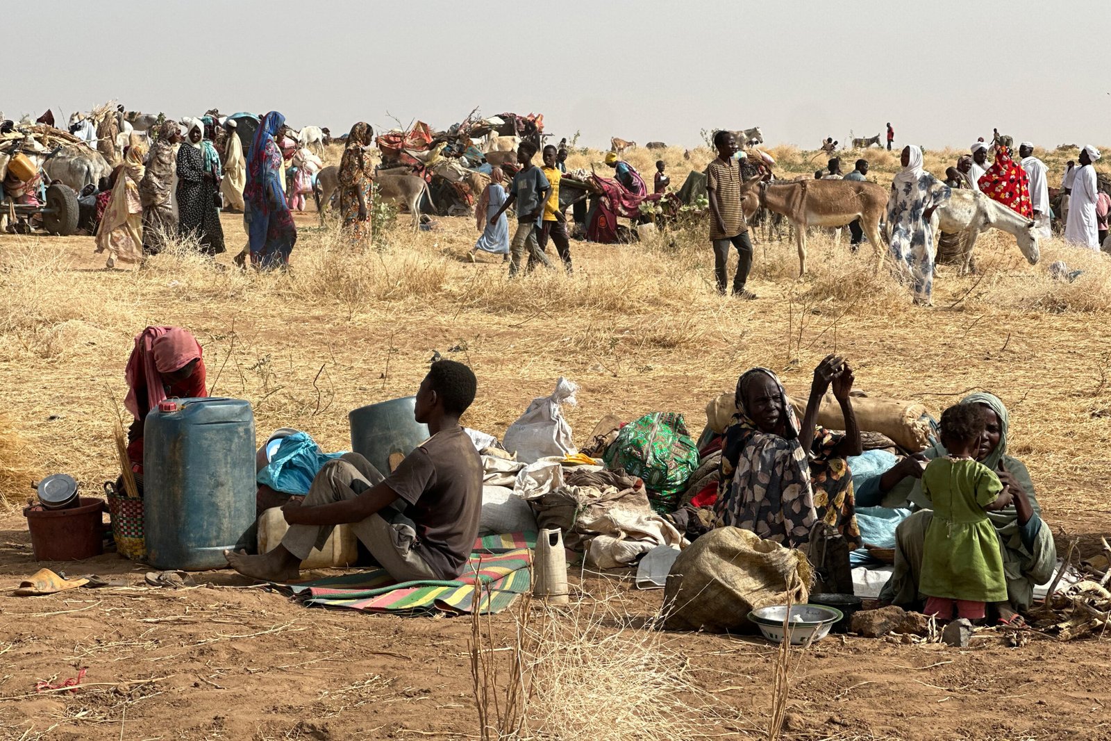 Aerial view of a Sudan displacement camp at dusk with thousands of tents stretching to the horizon, Kordofan region, 2026