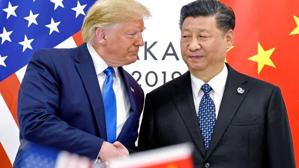 American and Chinese flags flying side by side representing the US China trade war and the Trump Xi Jinping summit scheduled for March 31 2026 in Beijing